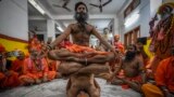 Hindu holy men display their yoga skills before media on International Day of Yoga at the Kamakhya temple in Guwahati, Assam, India.