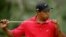 FILE - Tiger Woods blows on his putter on the 10th hole during final round play of the Tournament Players Championship golf tournament at the TPC at Sawgrass in Ponte Vedra, Florida, May 13, 2007. 