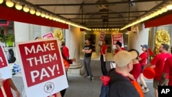 Hotel workers on strike chant and beat drums while picketing outside the Fairmont Copley Plaza hotel on Sept. 1, 2024, in Boston.