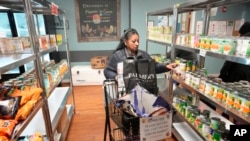 Betsy Quiroa shops at a market-style food pantry at the Carver Center in Port Chester, NY, Nov. 15, 2023.