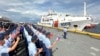 Philippine Coast Guard personnel wave Vietnamese and Philippine flags to welcome a Vietnam Coast Guard ship in Manila, Philippines, Aug. 5, 2024.