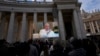 FILE - Pope Francis appears on a giant monitor set up in St. Peter's Square at The Vatican, Nov. 26, 2023, as he blesses the faithful gathered in the square.