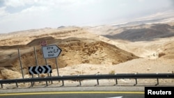 FILE - A road sign pointing to the direction of the southern Israeli city of Eilat is seen north to Eilat, Israel, June 12, 2018. 