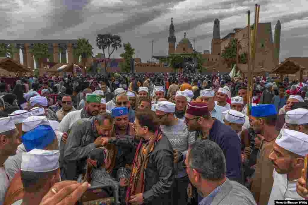 A celebration is held for the birthday of the 12th-century Sufi Sheikh Yusuf Abu'l-Hajjaj, with local visitors and religious leaders gathering outside Luxor Temple, which holds a mosque in his name, in Luxor, Egypt, Feb. 23, 2024.