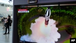 A TV screen shows a file image of North Korea's missile launch during a news program at the Seoul Railway Station in Seoul, South Korea, July 25, 2023.