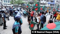 Protesters demanding the resignation of Prime Minister Sheikh Hasina gather in a protest in Dhaka, July 29, 2023, as police try to disperse them.