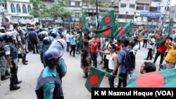 FILE - Protesters demanding resignation of Prime Minister Sheikh Hasina gather in a sit-in protest in Dhaka, July 29, 2023, as the police are trying to disperse them. 