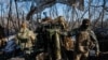 Servicemen of the 12th Special Forces Brigade Azov of the National Guard of Ukraine prepare to fire from a howitzer LH-70 towards Russian troops at a position near a frontline, Ukraine, Nov. 22, 2023.