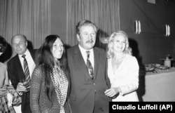 Buffy Sainte-Marie poses with British actor Peter Ustinov and American actress Carroll Baker at a party given in her honor in Rome, Italy, April 29, 1969.