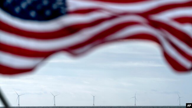 FILE - The five turbines of America's first offshore wind farm, owned by the Danish company, Orsted, are seen from a tour boat flying the American flag off the coast of Block Island, RI, Oct. 17, 2022.