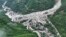 In this aerial photo released by Xinhua News Agency, the impact of flash floods and mudslides can be seen near Ridi Village, Kangding City, Garze Tibetan Autonomous Prefecture in southwestern China's Sichuan Province, Aug. 4, 2024. 