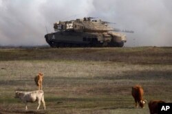 FILE - An Israeli Merkava tank is pictured during an exercise in the Israel-controlled Golan Heights on Jan. 11, 2016. The Biden administration wants approval to sell 45,000 shells for the tanks for Israel's offensive against Hamas in Gaza.