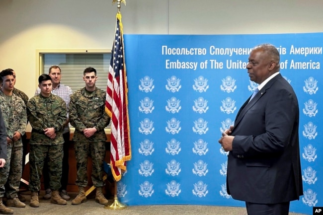 U.S. Secretary of Defense Lloyd Austin, right, speaks to employees of the U.S. embassy in Kyiv, Nov. 20, 2023.