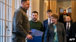 Swiss President Viola Amherd, Ukraine's President Volodymyr Zelenskyy and Andriy Yermak, head of the Ukrainian President's Office, walk to attend bilateral talks in Kehrsatz near Bern, Jan. 15, 2024.