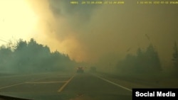 FILE - Smoke rises from wildfires in Hammonds Plains, Nova Scotia, May 28, 2023, in this screengrab obtained from a social media video.