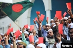 Supporters of Islami Andolan Bangladesh party attend a rally demanding to abolish what they call a "dummy election" and to reorganize a fair election under a caretaker government at the Baitul Mokarram National Mosque, in Dhaka, Jan. 9, 2024.