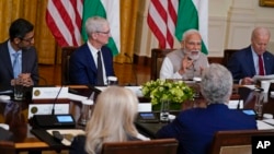 India's Prime Minister Narendra Modi speaks during a meeting with President Joe Biden and U.S. and Indian business leaders at the White House, June 23, 2023, in Washington. At left are Sundar Pichai, CEO of Google, and Tim Cook, CEO of Apple. 