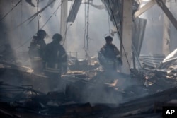 Emergency workers search for victims after Russian missile hit a supermarket in Kostiantynivka, Donetsk region, Ukraine, Aug. 9, 2024.