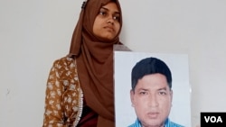 Anisha Islam Insha holds a photo of her father Ismail Hossain Baten. Baten's fate remains unknown after men from the paramilitary RAB battalion allegedly abducted him from Dhaka in 2019. "Please return my father to us," Insha urged security authorities. (Enam Islam for VOA)