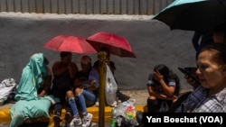 Hundreds of people from poor neighborhoods wait in front of a detention center in Caracas, Venezuela, looking for information about their relatives who were arrested during the protests against the election results, on Aug. 1, 2024. 