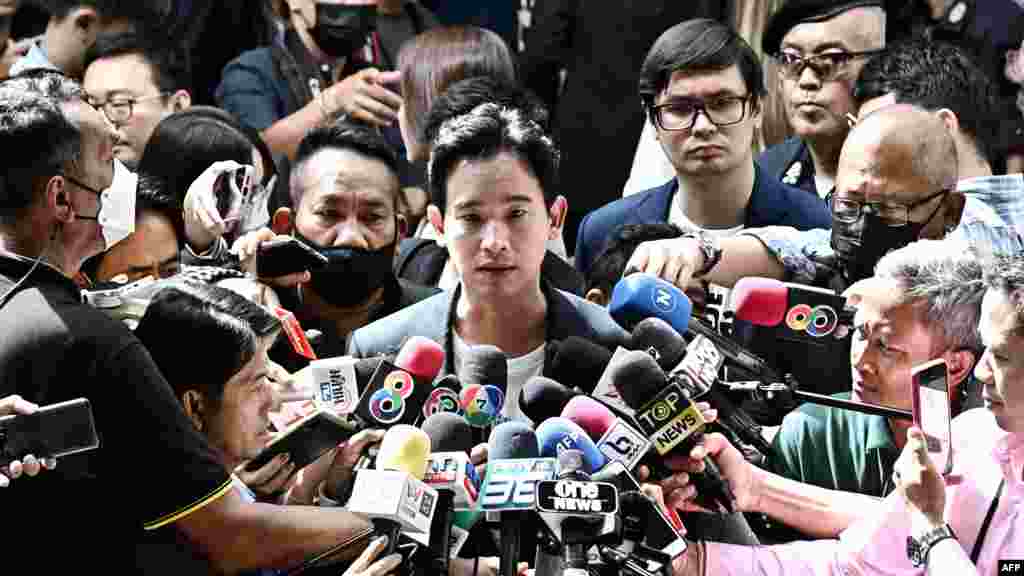 Move Forward Party leader and prime ministerial candidate Pita Limjaroenrat, center, talks to the media after accompanying his party's newly elected House of Representatives members to report to the Parliament in Bangkok.