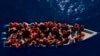 FILE - Migrants from Eritrea, Libya and Sudan sail a wooden boat before being assisted by aid workers of the Spanish NGO Open Arms, in the Mediterranean sea, about 30 miles north of Libya, June 17, 2023. 