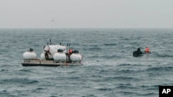 In this photo released by Action Aviation, the submersible Titan is prepared for a dive into a remote area of the Atlantic Ocean on an expedition to the Titanic on Sunday, June 18, 2023. (Action Aviation via AP)