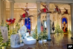 FILE - Holiday decorations adorn the Grand Foyer of the White House for the 2023 theme "Magic, Wonder, and Joy," Monday, Nov. 27, 2023, in Washington. (AP Photo/Evan Vucci)