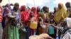 FILE — Somalis, displaced by a drought, receive food at a camp on the outskirts of Mogadishu, Somalia, March 30, 2017.