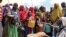 FILE — Somalis, displaced by a drought, receive food at a camp on the outskirts of Mogadishu, Somalia, March 30, 2017.