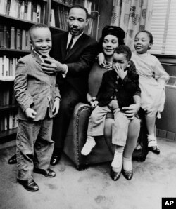 The family of Martin Luther King Jr. and Coretta Scott King at their Atlanta home in 1963. Dexter King, age 2, sits on his mother's lap. Also pictured are Martin III, age 5, and Yolanda, 7.