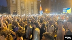 Građani drže telefone sa upljaneim svetlima ispred sedišta beogradske policije, 8. jula 2023. (Foto: VOA/Rade Ranković)