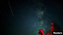 Astronomers observe the northern skies during the Perseid meteor shower in Kozjak, North Macedonia.