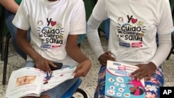 FILE - Teenage club members wear shirts that read in Spanish "I take care of my body and my health" at a session on sex education at a school on the weekend in Azua, Dominican Republic, Dec. 9, 2023.