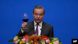 Chinese Foreign Minister Wang Yi gives a toast to invited guests after delivering a speech at a reception for Commemoration of the 45th Anniversary of China-U.S. Diplomatic Relations at the Diaoyutai Guest House in Beijing, Jan. 5, 2024. 