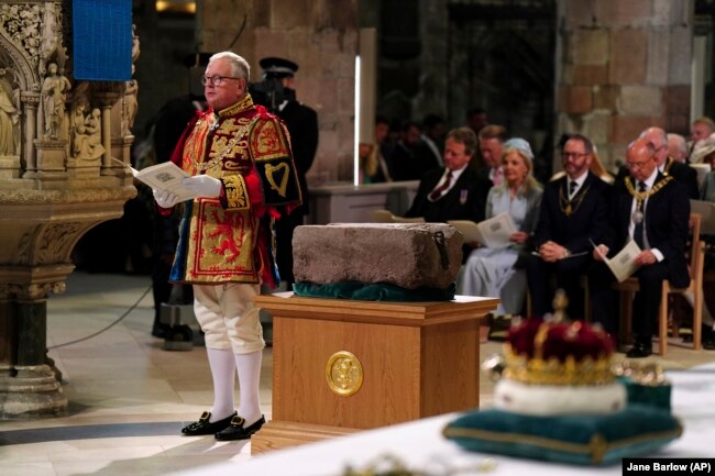 FILE - Lord Lyon King of Arms Joseph Morrow and the Stone of Scone at St Giles' Cathedral, July 5, 2023, in Edinburgh. (Jane Barlow/Pool photo via AP, File)