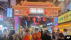 FILE - People go to the night market to shop in Taipei on June 29, 2023.