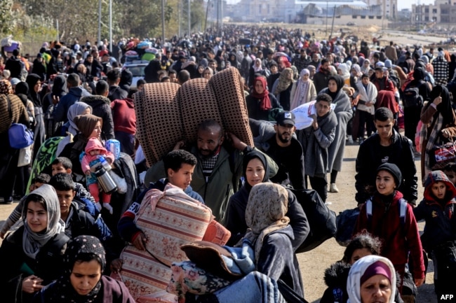 Palestinians carry some belongings as they flee Khan Younis to safer areas, Jan. 26, 2024.