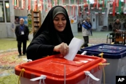FILE - A voter casts her ballot during the parliamentary and Assembly of Experts elections at a polling station in Tehran, Iran, March 1, 2024.