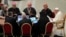 Pope Francis, right, speaks with a group of voting members during the opening session of the 16th General Assembly of the Synod of Bishops in the Paul VI Hall at the Vatican, Oct. 4, 2023