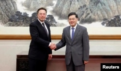 Chinese State Councilor and Foreign Minister Qin Gang meets Tesla Chief Executive Officer Elon Musk in Beijing, China, in this handout image released by China's Ministry of Foreign Affairs, May 30, 2023.