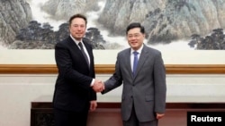 Chinese State Councilor and Foreign Minister Qin Gang meets Tesla Chief Executive Officer Elon Musk in Beijing, China, in this handout image released by China's Ministry of Foreign Affairs, May 30, 2023.