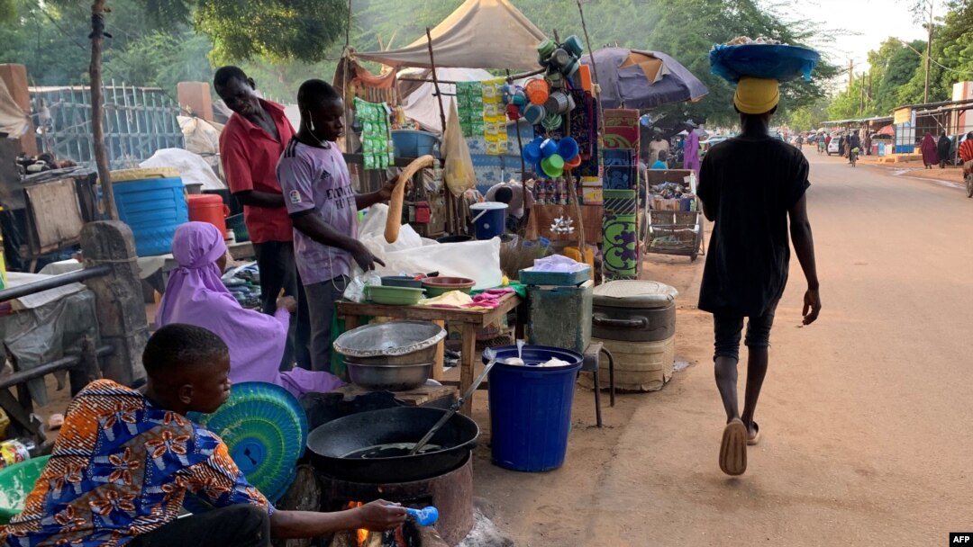 FILE - A man walks past a street side market in Niamey, Sept. 20, 2023. A lawsuit filed by Niger's transitional leaders over sanctions on Niger was dismissed on Dec. 7, 2023. Since the sanctions were imposed following the July coup, millions of citizens have struggled to get by. 