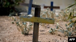 FILE - Wooden crosses made with the remains of boats used by migrants to cross the Mediterranean sea are seen in the cemetery where victims of shipwrecks are buried, on the island of Lampedusa, Italy, on Sept. 25, 2023.