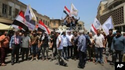 Demonstrators protest in front of the Iraqi central bank as currency plummets against the US dollar, in Baghdad, Iraq, July 26, 2023. 