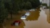 (FILE) Cars are immersed in flood water in a neighborhood where Typhoon Doksuri have caused heavy damage in China.