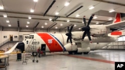 Crew members prepare to leave St. John's, Newfoundland, on a Coast Guard HC-130 Hercules airplane to help search for the submersible Titan, June 21, 2023. (U.S. Coast Guard via AP)
