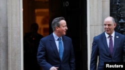 Britain's former Prime Minister and newly appointed Foreign Secretary David Cameron walks outside 10 Downing Street next to top civil servant in the Foreign Office Philip Barton, in London, Britain, Nov. 13, 2023. 