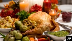 FILE - A grill-roasted brined turkey is presented on a table in Concord, New Hampshire.