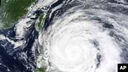 FILE: This Monday, May 29, 2023 satellite image released by NASA shows Typhoon Mawar. The U.N. World Meteorological Office also tracks weather and its impact on people around the world. 